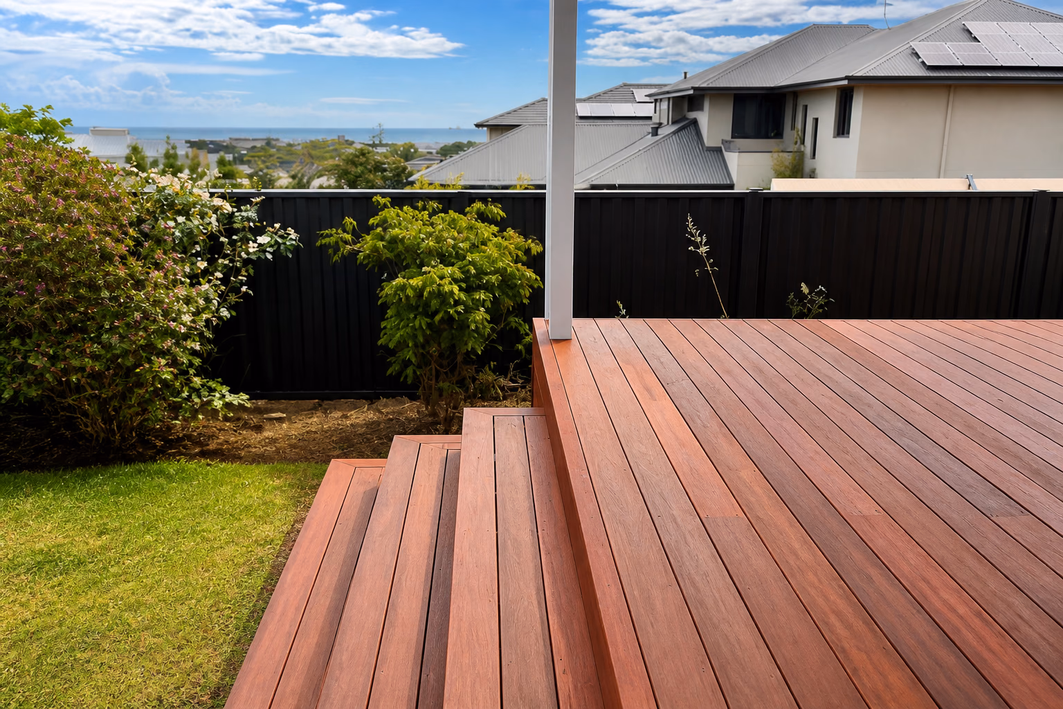 A finished hardwood deck with wrap-around steps