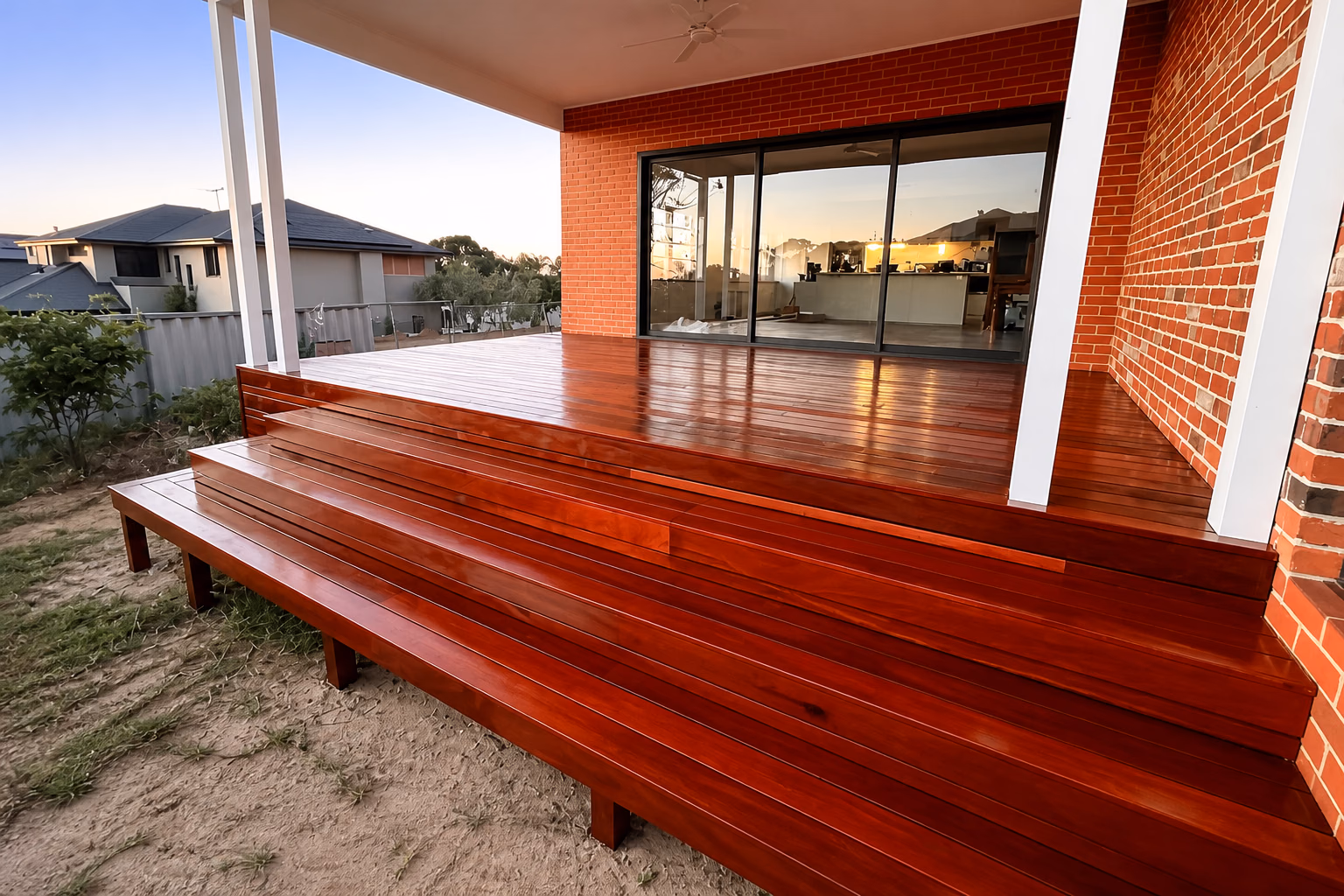 Wrap-around hardwood steps built against a red brick house