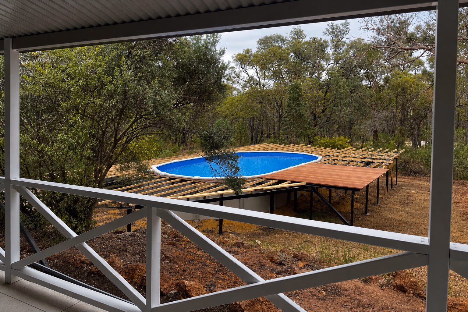 Timber joists and the first boards around an above-ground pool