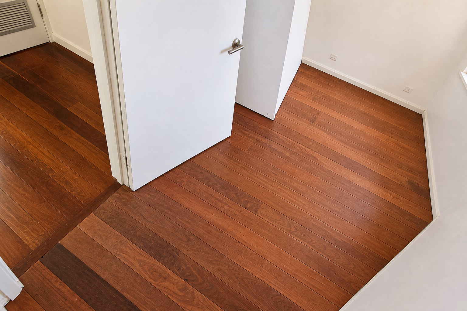 Newly laid hardwood boards in a room during installation